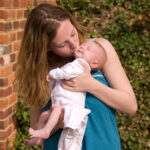 Young woman kissing a baby